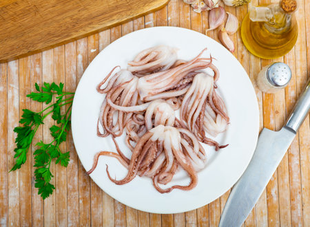 Raw squid tentacles served on plate