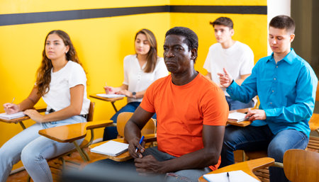 Attentive students at their desks in university auditoriumの写真素材