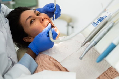 Female patient during dental treatment in dentist officeの写真素材