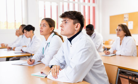 Portrait of doctors different age who writing exercises at lessonの写真素材
