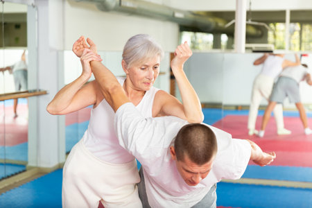 Woman self defense training gym learning to do painful gripの写真素材
