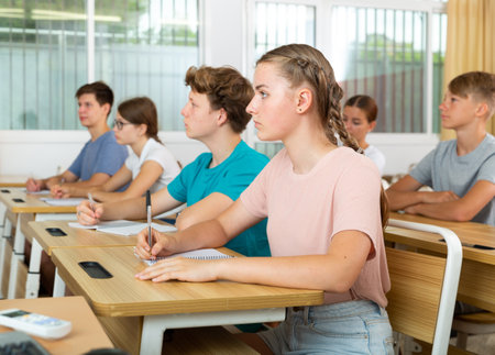 Teenager students sitting at desksの写真素材