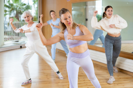 Group are practising arch movement in step jazz dance in fitness gym