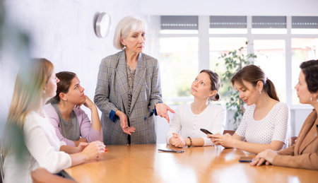 Senior woman team leader stands and leads staff meeting.Group work, teamworkの写真素材