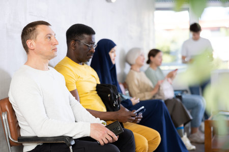 Man waiting for interview in lobby of job centerの写真素材