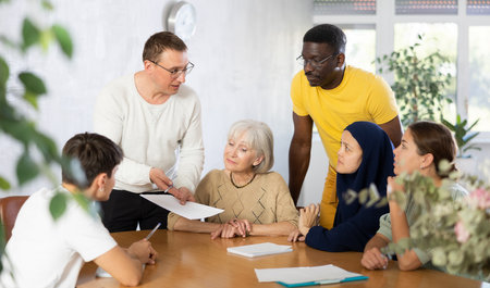 Group of multinational people making notes at tableの写真素材