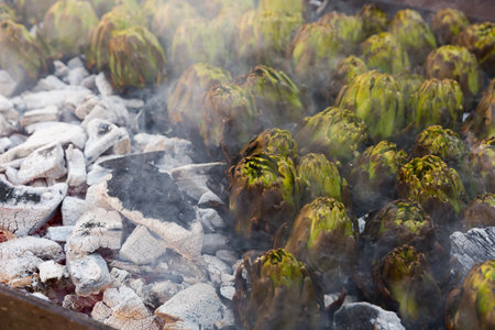 Artichokes being grilled on charcoalの写真素材