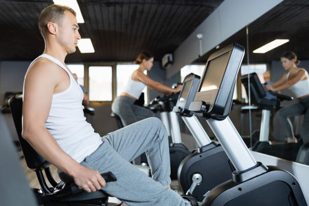 Young man exercising on exercise bike