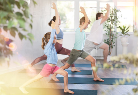 Family with two children doing pilates in studio