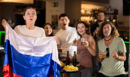 Group of fans in bar with Russian flagの写真素材