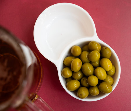 Spanish tapas from marinaded green olives at plateの写真素材