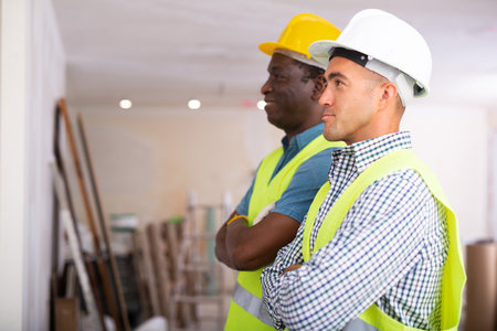 Portrait of two professional builders doing finishing workの写真素材