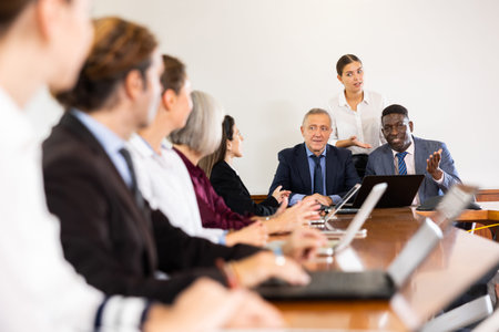 Executive team holding corporate meeting at office with assistance secretarys support