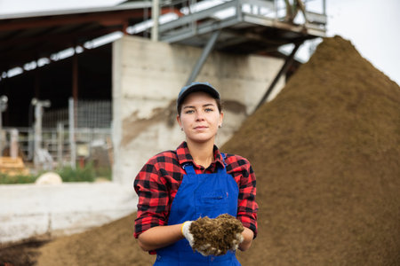 Young woman holding handful of dung