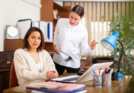 Irritated woman boss scolding manager for incompetenceの写真素材