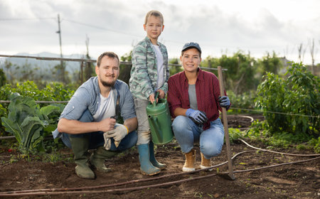 Family of farmers standing in the gardenの写真素材