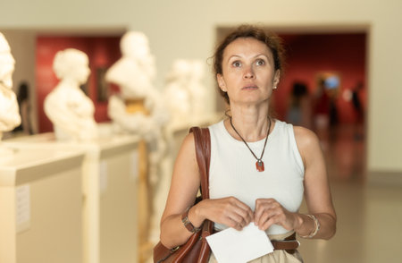 Positive woman looking at ancient bas-reliefs in old museumの写真素材