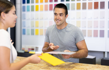 Amiable sales assistant of paints store consulting female buyerの写真素材
