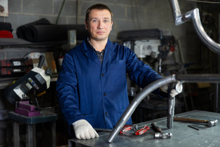 Adult man posing in metallurgical workshop