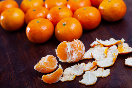 Closeup of fresh peeled clementines on wooden tableの写真素材