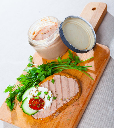 Canape with pate and young cheese at fresh bread, served with greensの写真素材