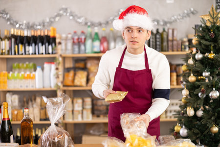 Male salesman behind a grocery counterの写真素材