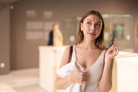 Girl view pictures and icons in museum hallの写真素材