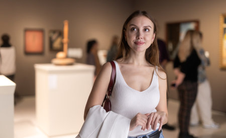 Girl view pictures and icons in museum hallの写真素材