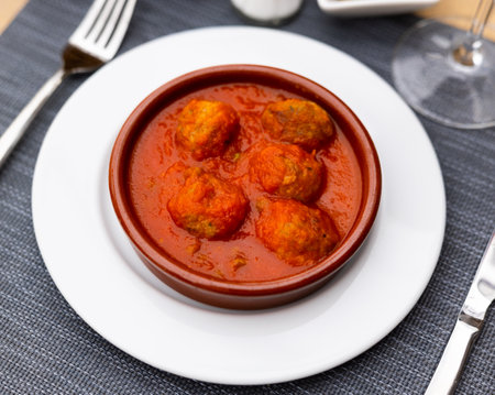 Appetizing meatballs with tomato sauce served on platterの写真素材