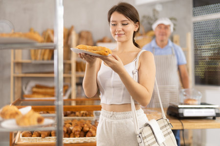Young woman buyer with bocadillo in bakery