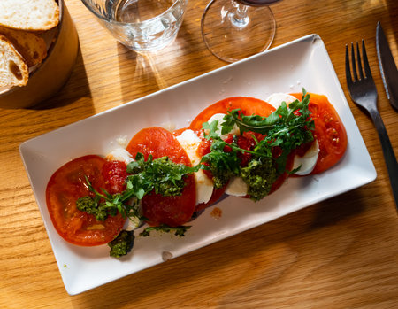 Caprese salad served with arugulaの写真素材