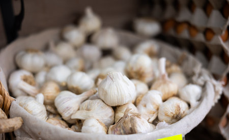 Garlic in basket on counter in market close upの写真素材