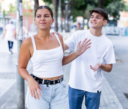 Displeased girl stopping stranger guy flirting with her on city street