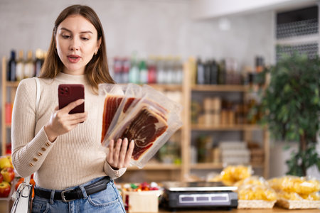 Young woman scanning qr code of jamonの写真素材