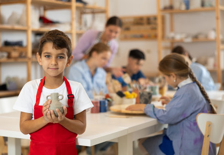 Little boy standing in art studioの写真素材