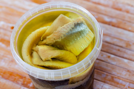 Pieces of pickled herring served with onionsの写真素材
