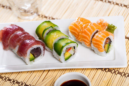 Set of urumaki rolls with salmon, tuna, avocado and crabの写真素材