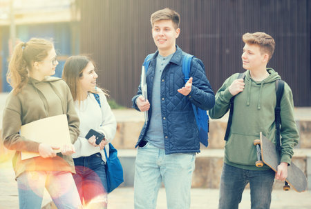 Teenage students talking outside after lessonsの写真素材