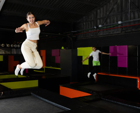 Woman sportswoman fitness jumping on club trampoline