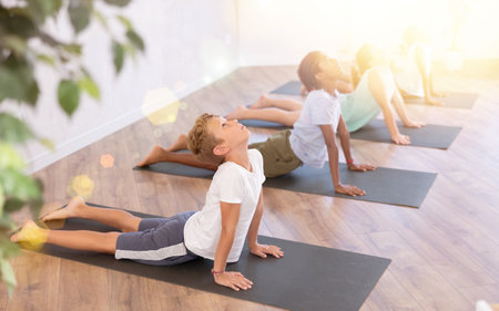 Group of multiethnic children doing yoga in studioの写真素材