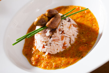 Delicious chicken heart with rice in a sea of hot tomato-cream sauceの写真素材
