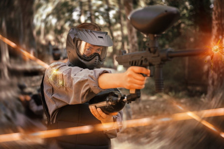 Paintball player recklessly aims with a gun on battlefieldの写真素材