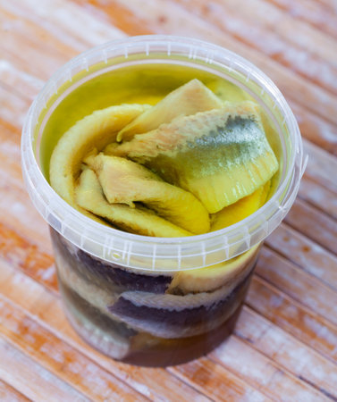 In plastic bucket containers are large pieces of salted herring fillet, freed from bonesの写真素材