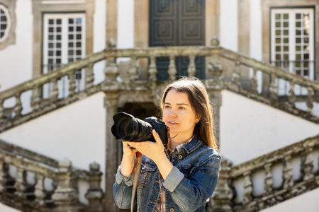 Woman photographer walking with camera on courtyard of Mateus Palaceの写真素材
