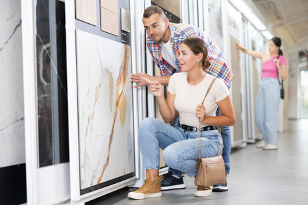 Couple of man and woman choose tiles in storeの写真素材