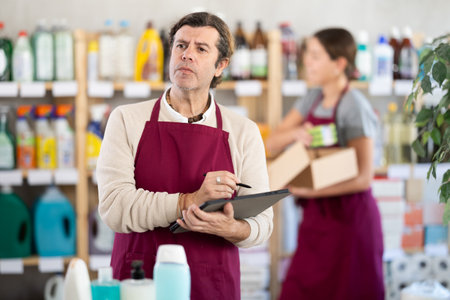 Household goods store owner using tablet to manage inventoryの写真素材