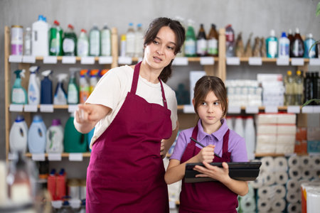 warehouse worker with an assistant conducts an inventory