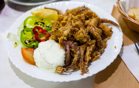 Popular Spanish tapa rejos - fried spicy tentacles of squid served with lemon slice