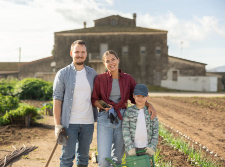 Family of farmers standing in the garden