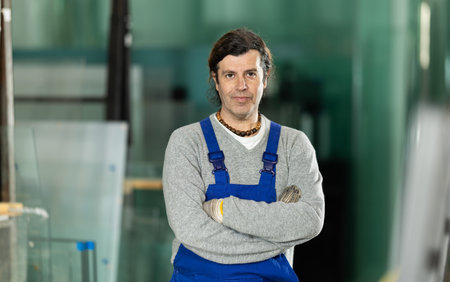 Adult man working in glass factory